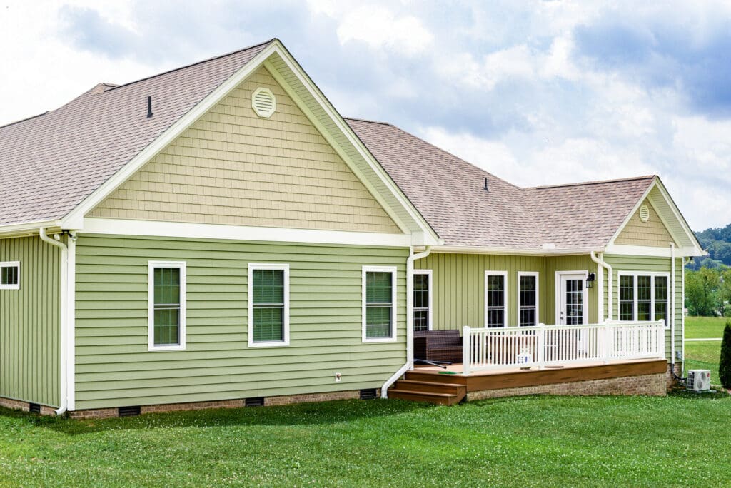 Home with lap vinyl siding in yellow and green
